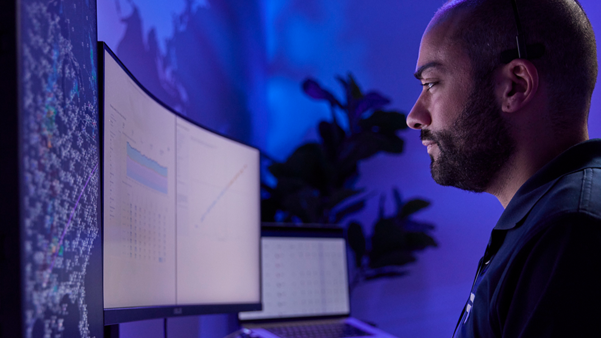 Man sitting in front of a large computer monitor